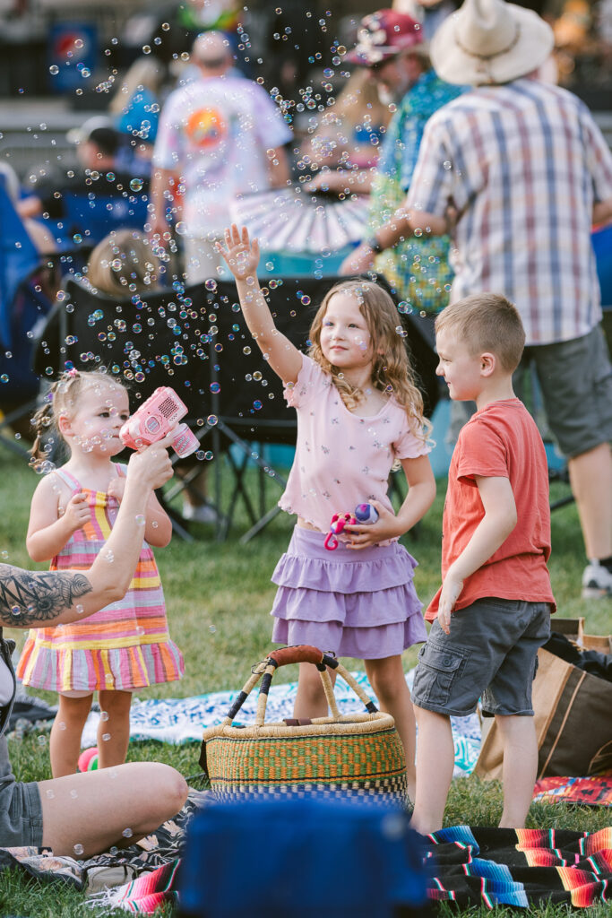 little kids playing with bubbles