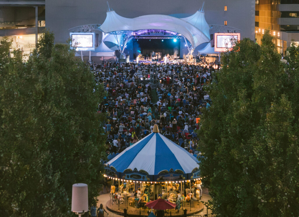 aerial shot of the carousel and a crowd at an outdoor concert