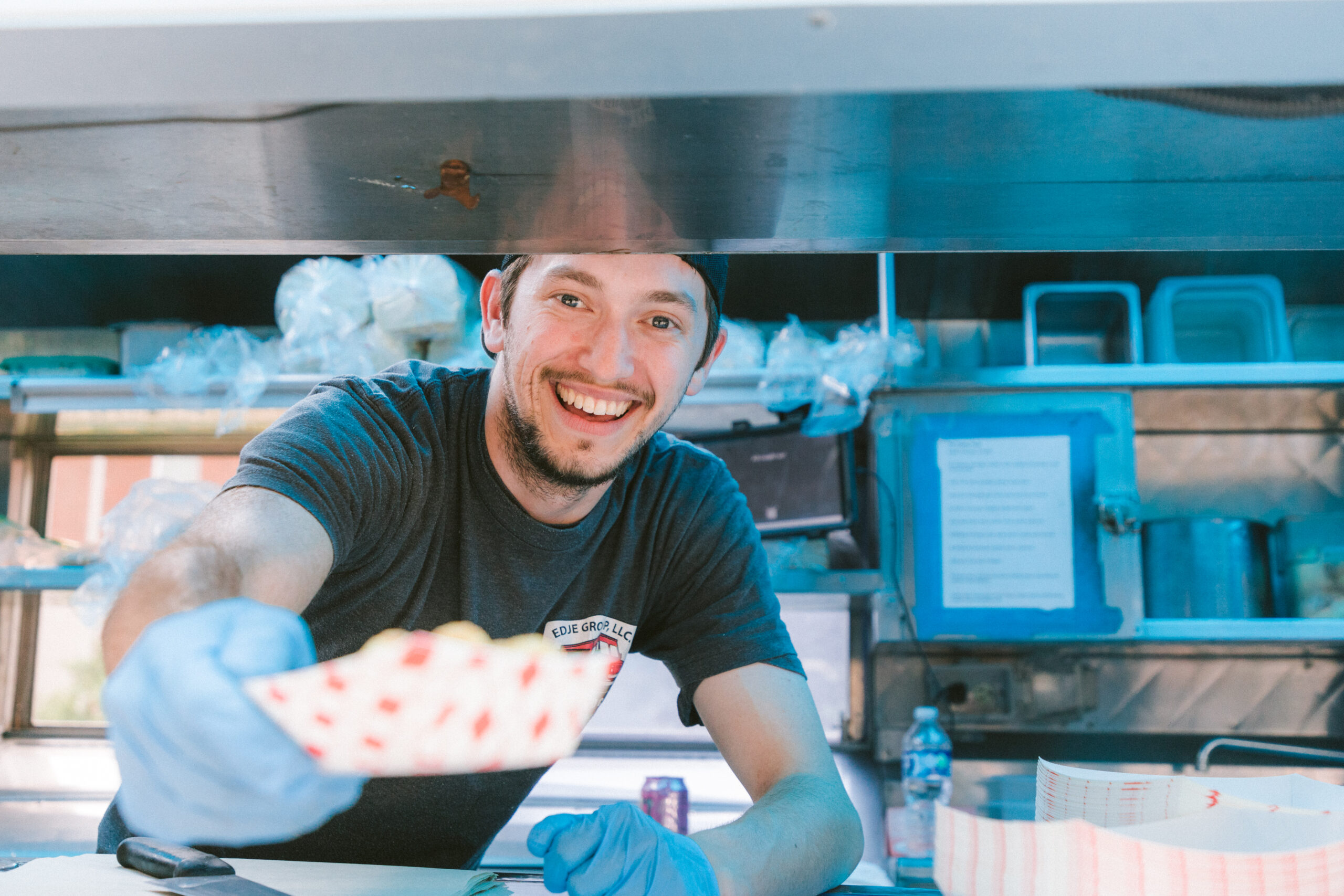 guy handing over food in a food truck