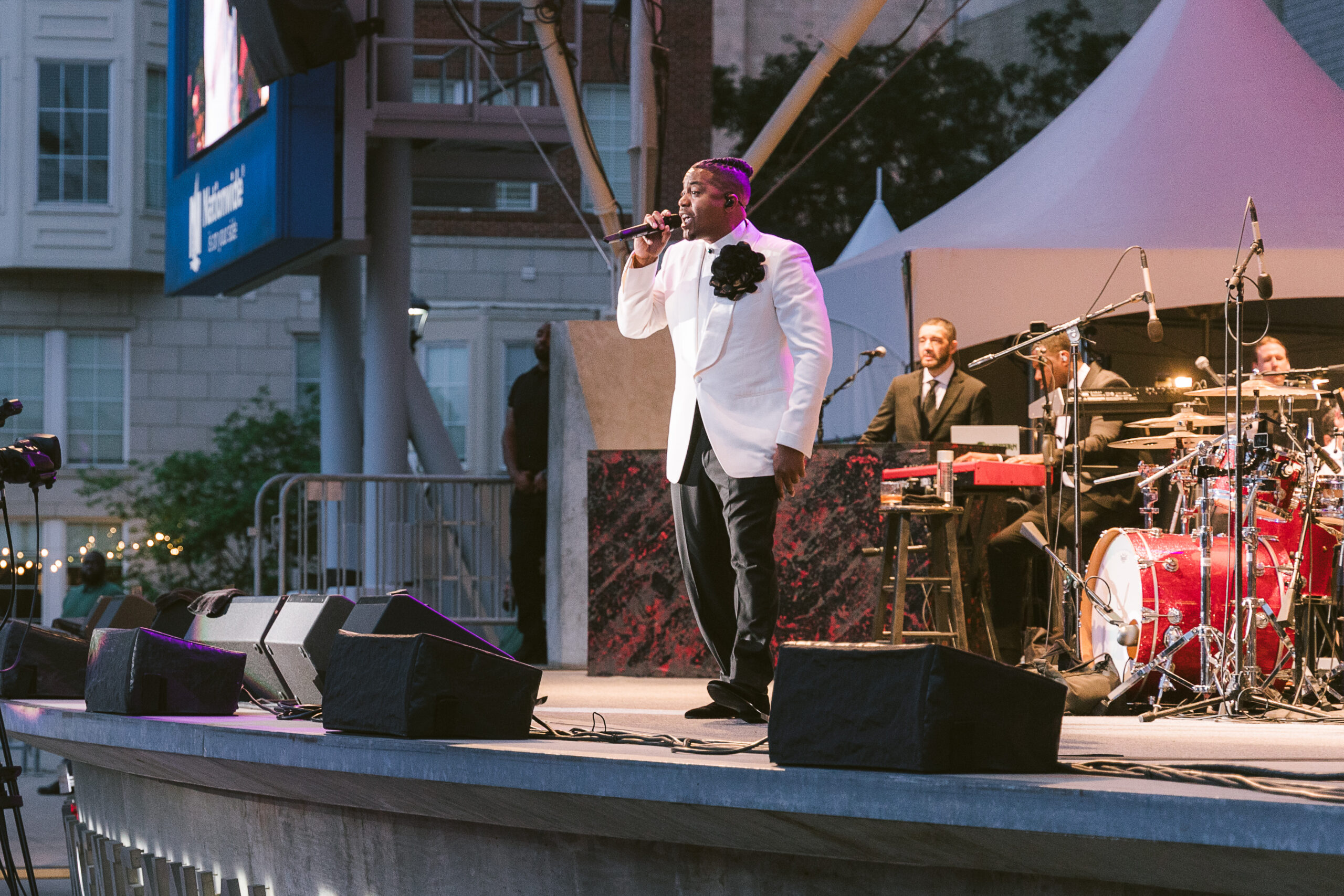 man in suit performing on stage