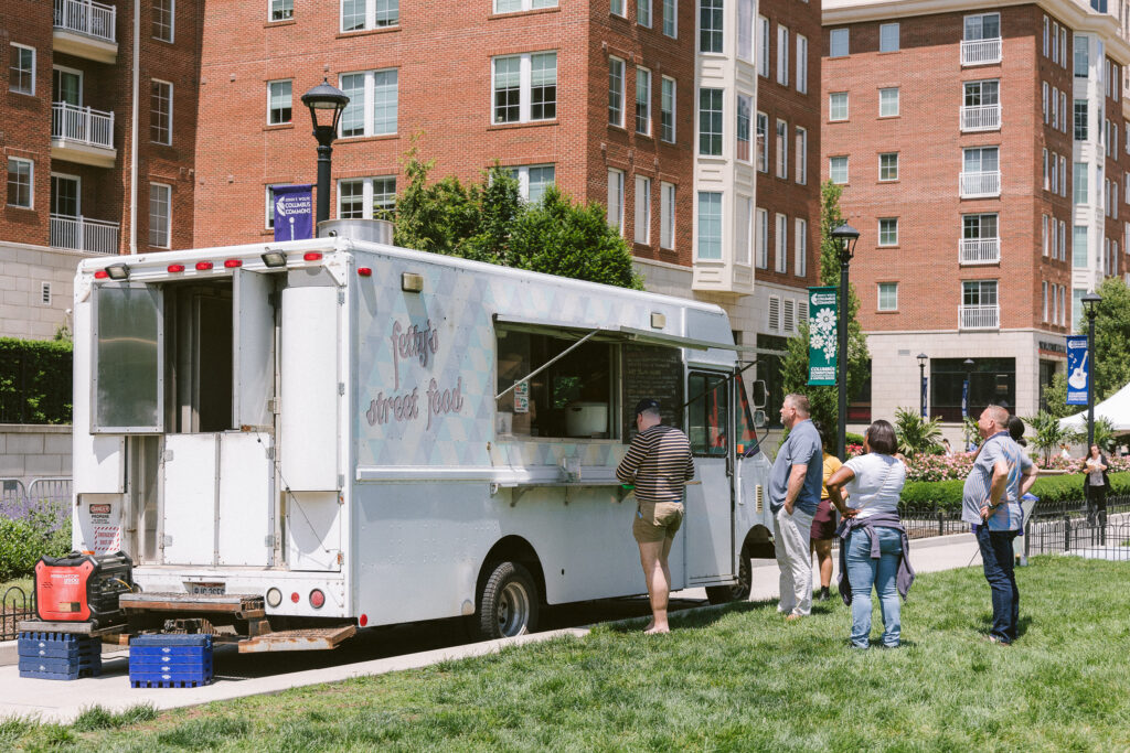 people waiting in line at the food truck