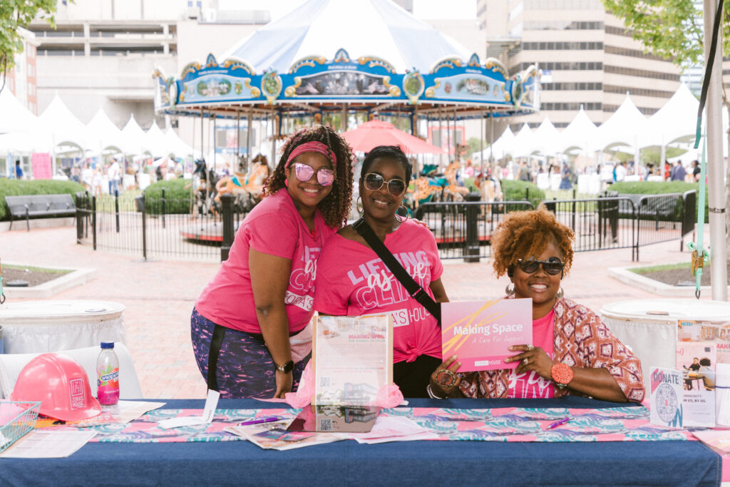 women wearing pink at a booth